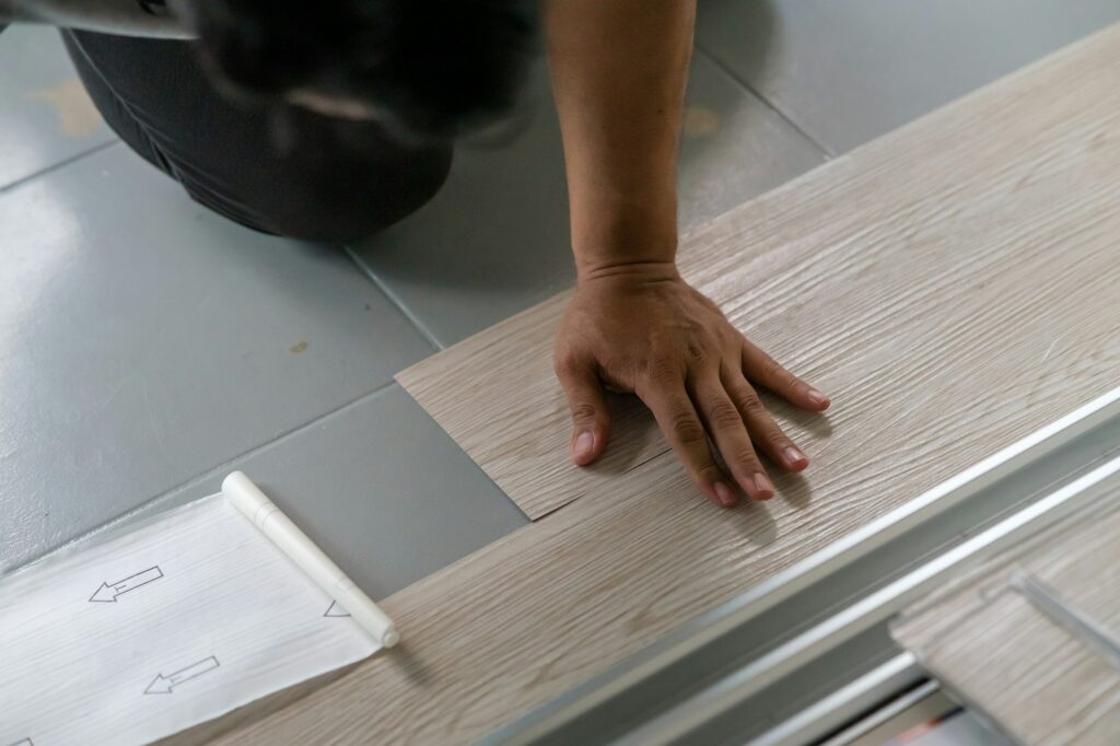 Vinyl floor installation, worker, DIY at home.
