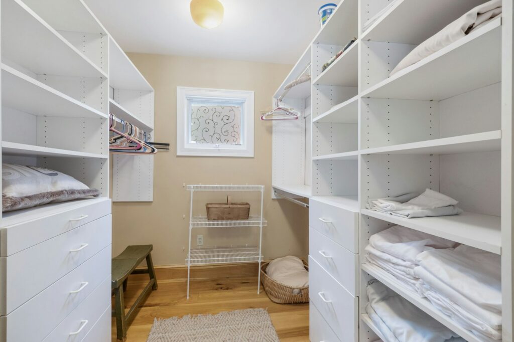 Interior shot of a closet with white built-in drawers.