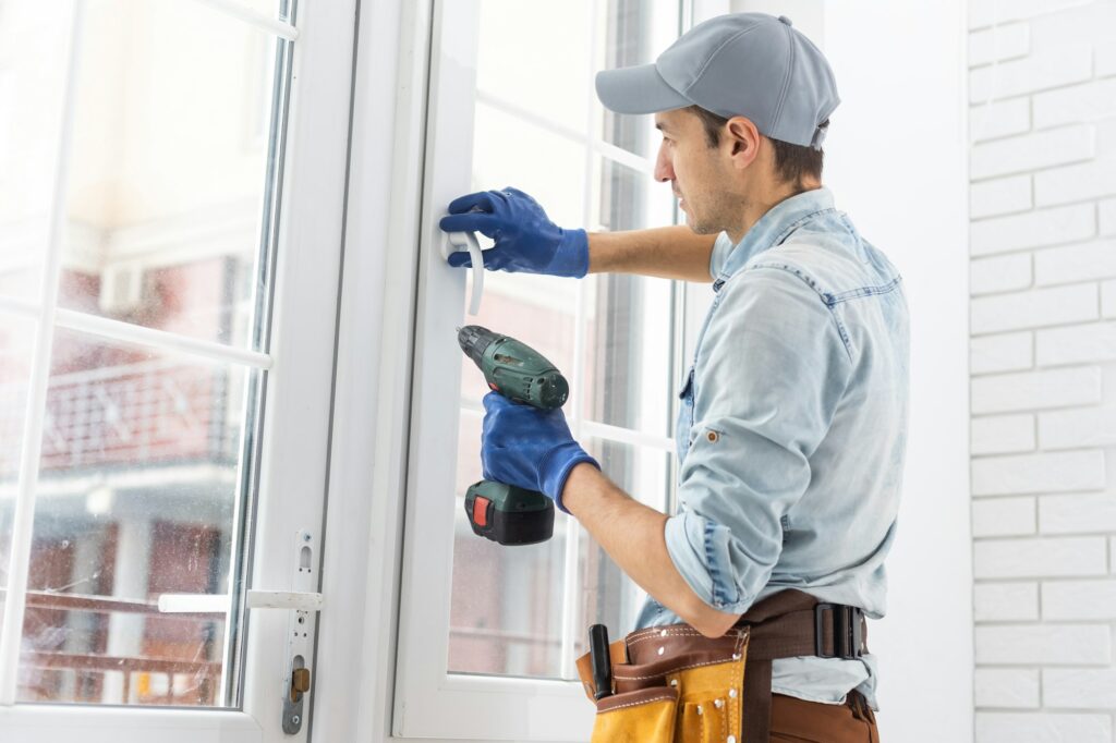 The worker installing and checking window in the house